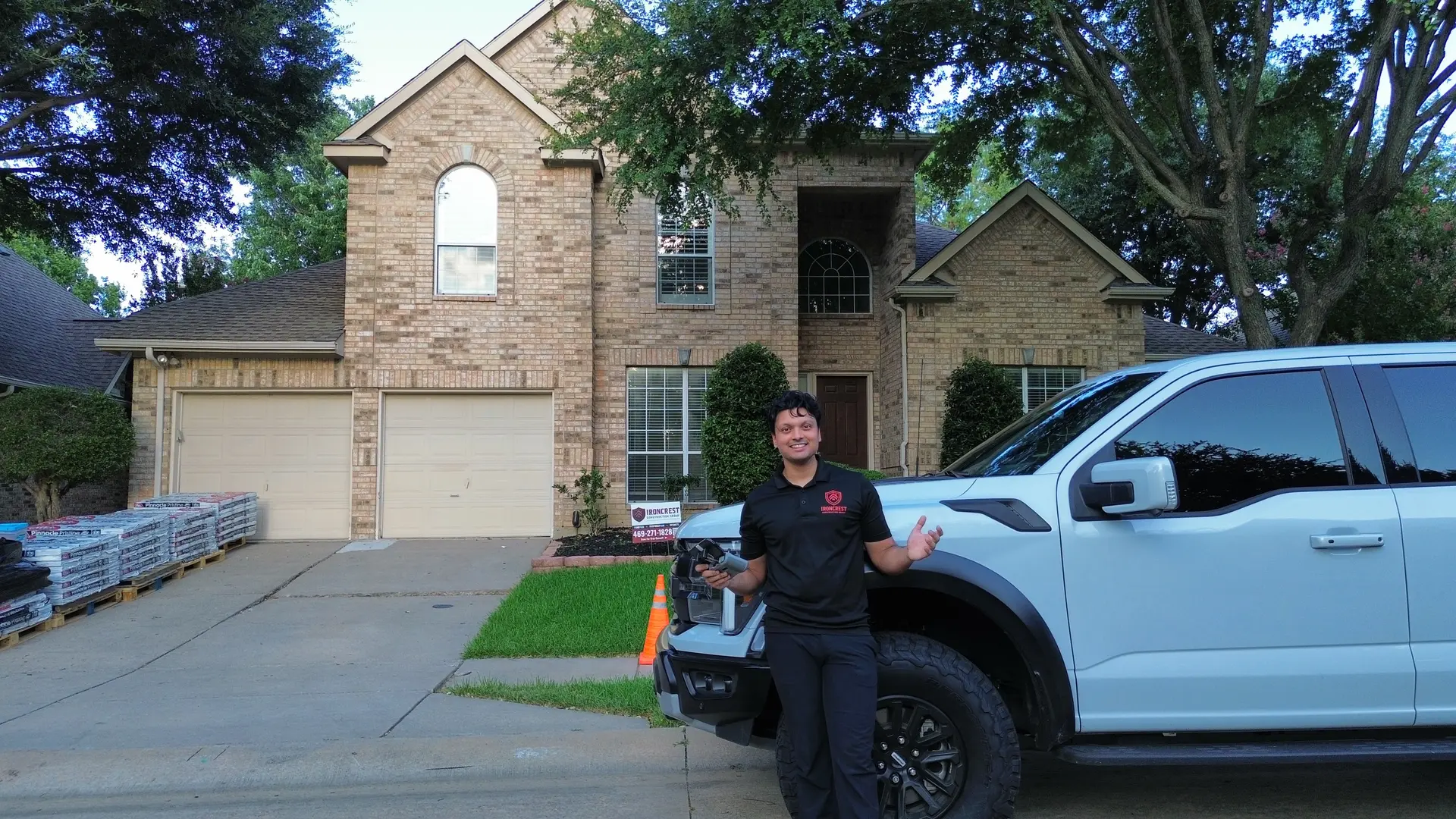 IronCrest Construction Group owner on-site with company truck and roofing materials in North Texas